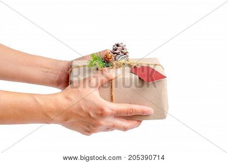 Close up woman hand holding Christmas present box isolated on white backgroundGift giving on holiday seasonal concept.