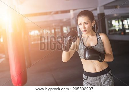 Asian Young Woman Doing Exercise With Thai Boxing (muay Thai) Equipment In Gym. Health And Fitness C