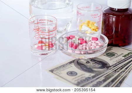 Medicine pills or Capsules with Money dollar Medical or pharmacy prescription for health. Business finance concept. Cost of the healthy life.