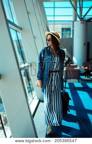 Woman posing on camera in departure hall