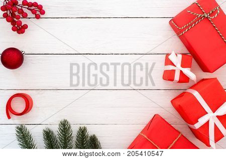 Christmas and New Year background. Christmas presents in red boxes with decoration rustic elements on white wooden. Creative flat lay top view design