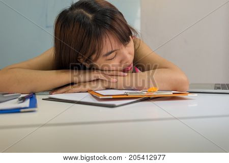 Drowsy girl falling asleep at office in working time