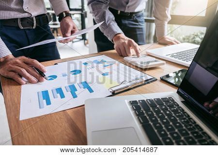 Business team meeting working with new startup project discussion and analysis data the charts and graphs. Digital tablet calculator laptop computer using Business finance and accounting concept.