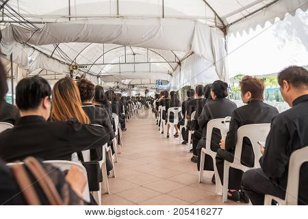Thai mourners wearing black color waiting in The Grand Palace to pay tribute and respect to their beloved Rama 9 Thai King Bhumibol Adulyadej