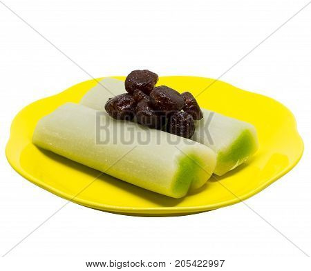 Caramelized Star gooseberry (Star gooseberry in syrup) on top two snow skin soft cake bars (Kanom Goh) on yellow dish isolated on white background with clipping path. Close up of thai dessert.