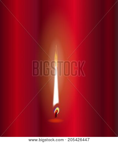 A candle flame flickering against a red background