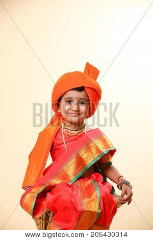 cute indian child in traditional style , posing