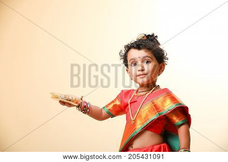 cute indian child in traditional style , posing
