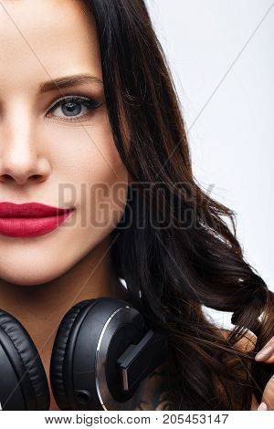 sexy girl DJ in top and pantyhose on a white background