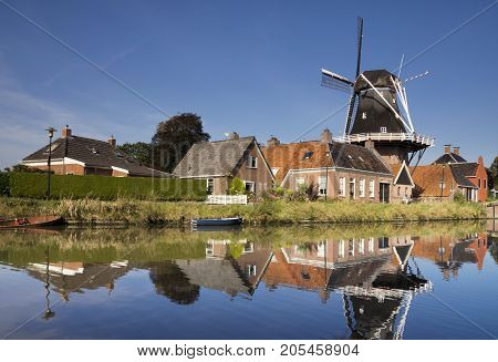 The Hunsingo windmill along the Boterdiep canal in the Dutch village Onderdendam