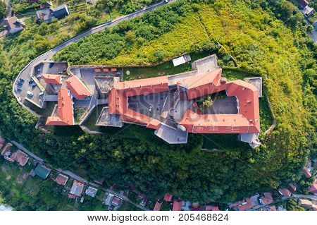 Aerial view of the Majestic Fortress - Palanok Castle towering above the city of Mukacheve, Ukraine. Top view, from above