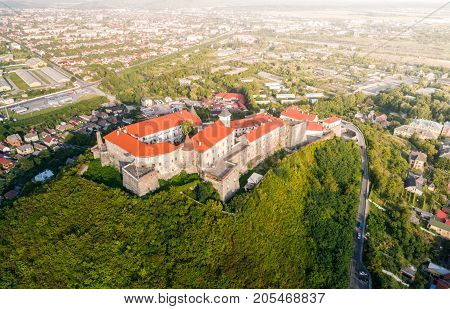 Aerial view of the Majestic Fortress - Palanok Castle towering above the city of Mukacheve, Ukraine.