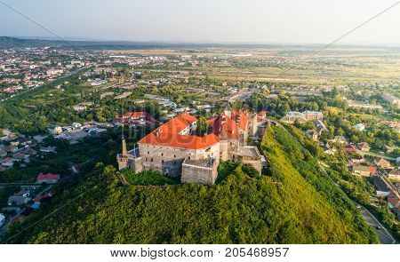 Aerial view of the Majestic Fortress - Palanok Castle towering above the city of Mukacheve, Ukraine.