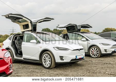 PRAGUE CZECH REPUBLIC - SEPTEMBER 23 2017. Two white cars Tesla Model X with opened door. Tesla Model X on the scraper car park.