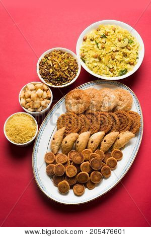 stock photo of  Diwali food or Diwali snacks or Diwali sweets like anarsa, bakarvadi, chakli, sev, bhujiya, shankar pale and chivda or chiwada, karanji, favourite indian diwali recipe, selective focus