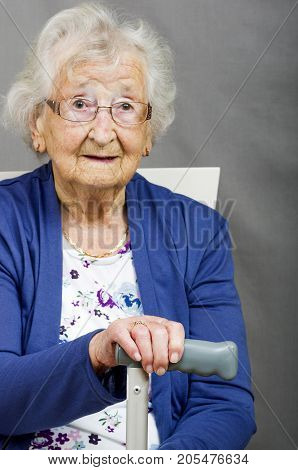 Senior Citizen with a Walking Stick
Elderly lady sat holding her walking stick.