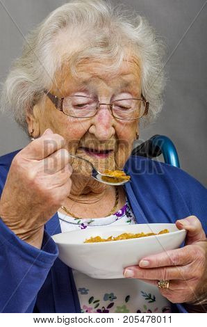 Senior Citizen eating.
Senior lady eating a bowl of cereals