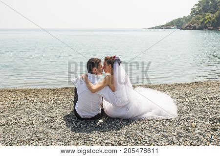 Romantic dating. Young loving couple walking together by the beach enjoying sea.
