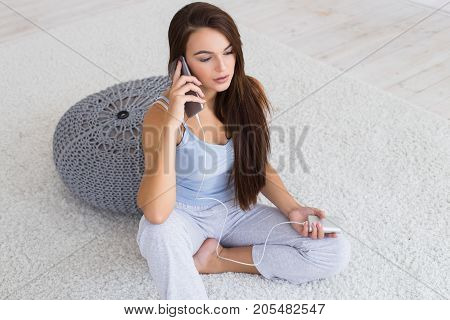 Portative charge in woman's hands. Portrait of beautiful brunette woman. Woman charging her phone. Beautiful woman talk on mobile phone.