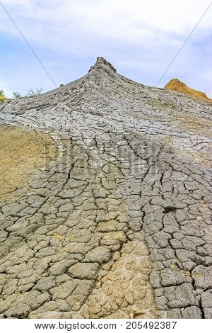 Bubbling mud. Landscape with muddy volcano at sunset - landmark attraction in Buzau, Paclele mari, Romania