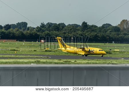 Dusseldorf, Germany - 03.09.2017: ADAC air ambulance taxi plane towards the runway to depart Dusseldorf International Airport