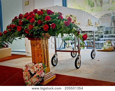 closeup shot of a colorful casket in a hearse or chapel before funeral or burial at cemetery