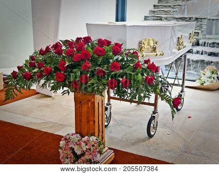 closeup shot of a colorful casket in a hearse or chapel before funeral or burial at cemetery