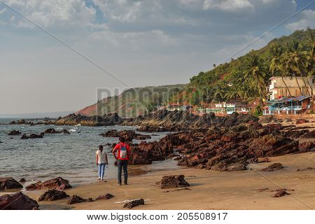 The Man And Woman Walking On Arambol Beach
