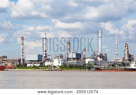 Factory of gas plant in the river and smoke emitted from the factory