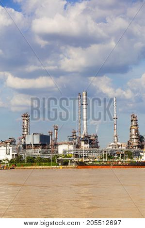 Factory of gas plant in the river and smoke emitted from the factory
