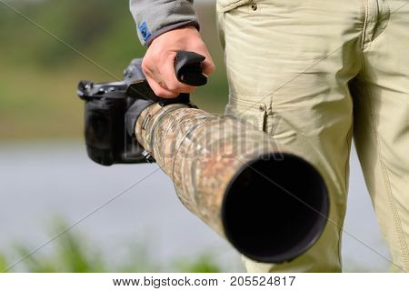 Close professional wildl ife photographer in nature