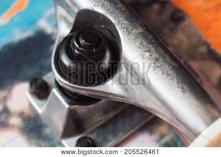 Close up of skateboard parts on black background. Safety construction, adjustment and repairing of professional extreme skateboarding elements. Kingpin, hanger, baseplate, top view