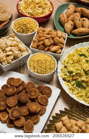 stock photo of  Diwali food or Diwali snacks or Diwali sweets like anarsa, bakarvadi, chakli, sev, bhujiya, shankar pale and chivda or chiwada, karanji, favourite indian diwali recipe, selective focus
