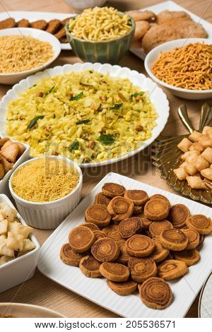 stock photo of  Diwali food or Diwali snacks or Diwali sweets like anarsa, bakarvadi, chakli, sev, bhujiya, shankar pale and chivda or chiwada, karanji, favourite indian diwali recipe, selective focus