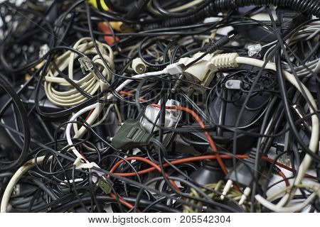 a bunch of tangled wires, connectors and cables
