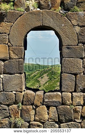Window in brick wall of the medieval armenian fortress Amberd
