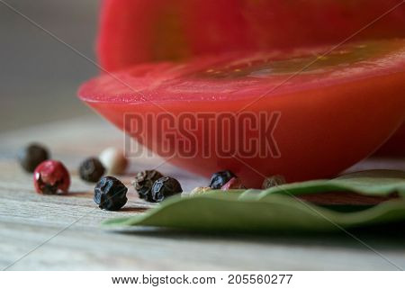 Macro of tomato with pepper on the wood