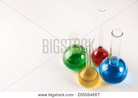 Test Tubes And Flasks With Colorful Liquids Isolated On White