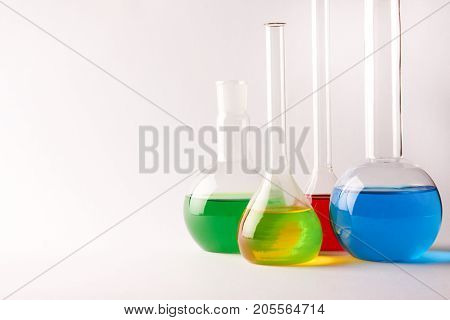 Test Tubes And Flasks With Colorful Liquids Isolated On White