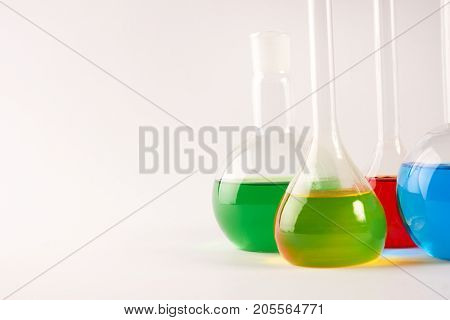 Test Tubes And Flasks With Colorful Liquids Isolated On White
