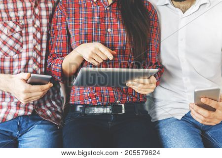 Portrait of unrecognizable peole using tablet and smartphone. Technology concept