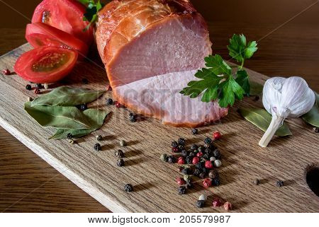 Smoked pork with pepper and garlic on wood