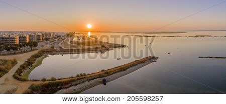 Sunrise aerial seascape view of Olhao salt marsh Inlet waterfront to Ria Formosa natural park. Algarve. Portugal.