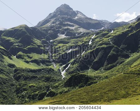 Alpine massif, beautiful Alpine canyon in Austria. Alpine Gastein Valley in summer. Mountains and pastures. Fresh air and healthy virgin nature. Excursional destination for hiking, vacation.