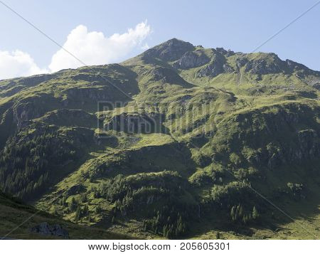 Alpine massif, beautiful Alpine canyon in Austria. Alpine Gastein Valley in summer. Mountains and pastures. Fresh air and healthy virgin nature. Excursional destination for hiking, vacation.