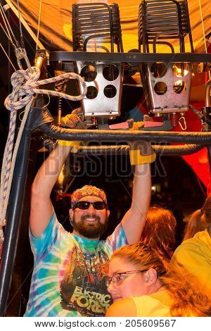 Seymour WI - August 12 2017: Hot air balloon pilot lighting his burners during Hamburger Fest in Seymour WI. Hot air balloons are an integral part of the annual festival which celebrates Seymour as the birthplace of the hamburger.