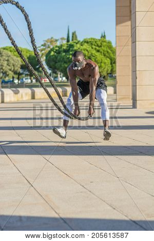 Male Muscular Training With Battle Ropes And Training Mask