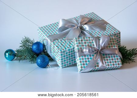 Gift boxes with silver bow on light background