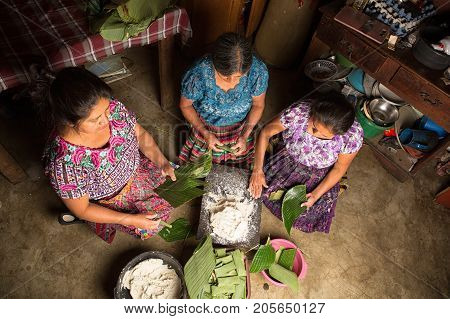 January 20, 2015 San Pedro La Laguna, Guatemala: Mayan Women In Traditional Wear Preparing Food Toge