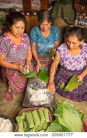 January 20, 2015 San Pedro La Laguna, Guatemala: Mayan Women In Traditional Wear Preparing Food Toge